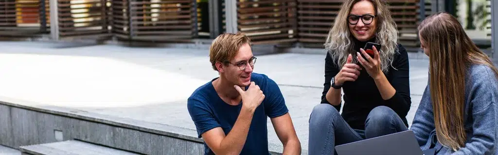 A group of staff sit outdoors and talk after attending wellbeing workshops