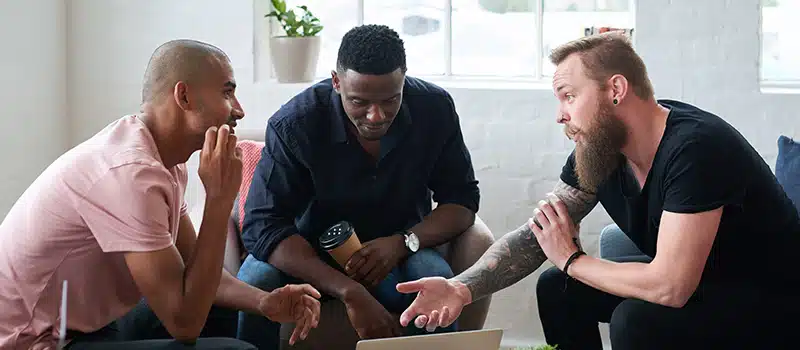 A group of men talking as part of movember activities at work
