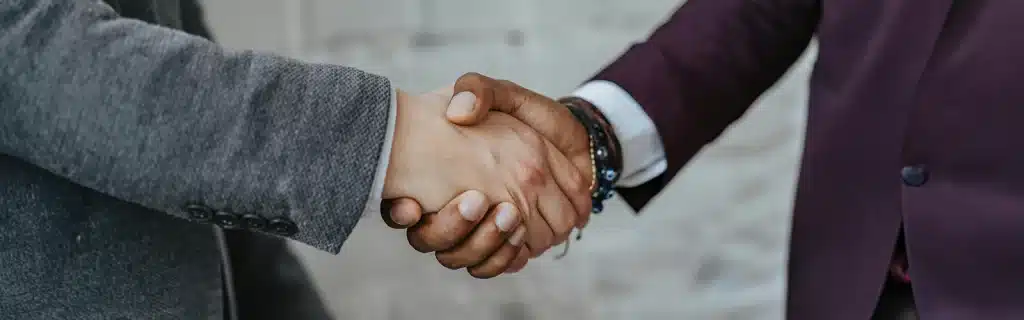 Two workers shaking hands, illustrating the concept of engagement and retention