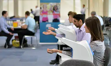 A group of employees undergoing blood pressure testing