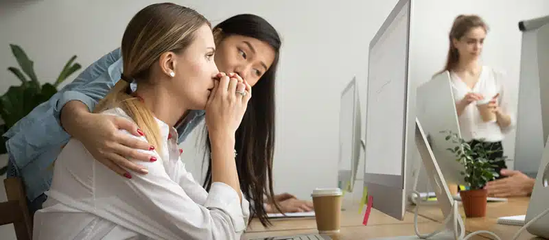 A Wellbeing Champion with her arm around an upset-looking colleague