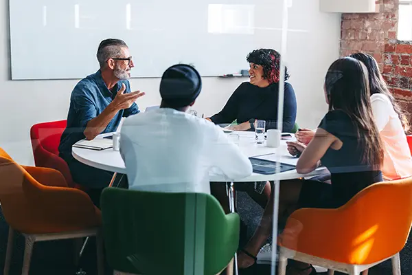 A group of staff sat around a table in a meeting