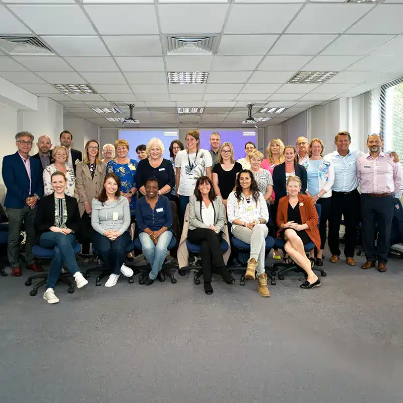 A group of attendees smiling at the camera during a Managing Mental Health course