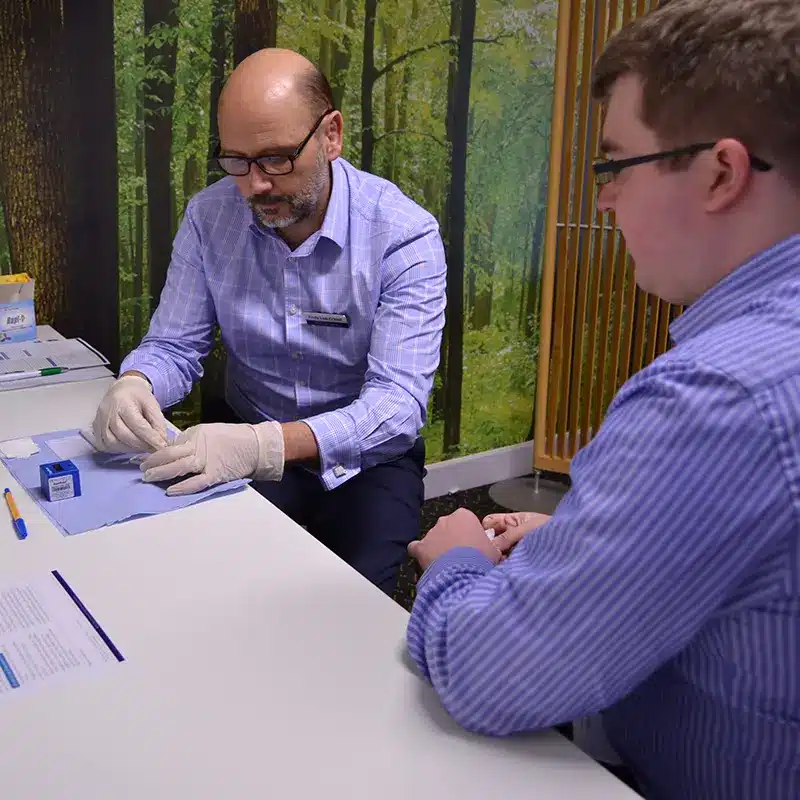 A New Leaf Health practitioner carrying out a workplace vitamin D test on an event attendee