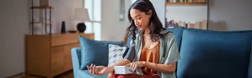 A woman sat on a sofa engaging in a workplace health check