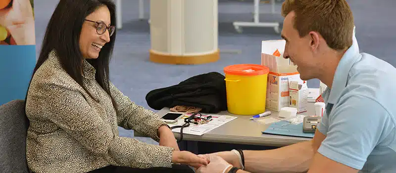 An employee and a New Leaf Health practitioner during an employee health check as part of a workplace wellbeing programme