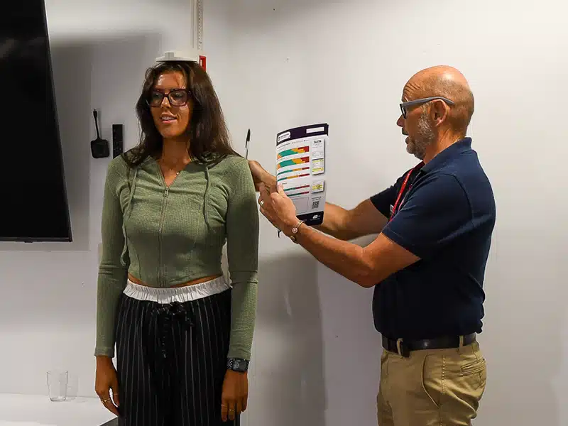 A woman having her height measured by a New Leaf Health practitioner as part of an Employee Health Check event