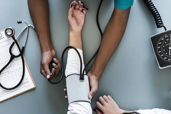 A woman's arm with a blood pressure measurement cuff as part of a Know Your Numbers blood pressure check
