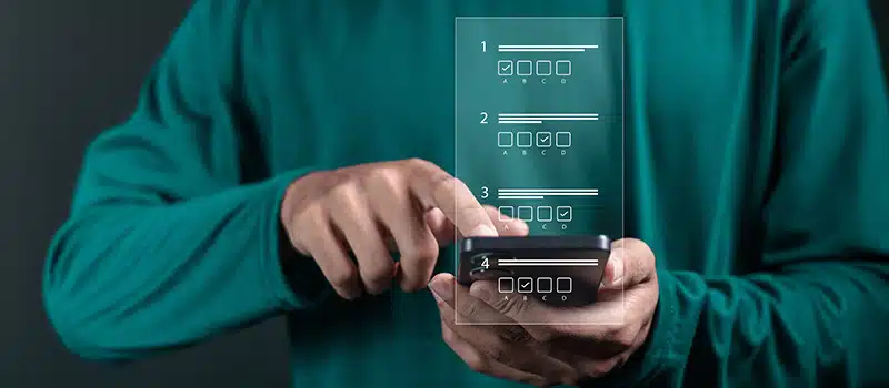 A person on a phone taking part in an employee wellbeing survey on their phone, with a digital visualisation of multiple choice questions overlayed