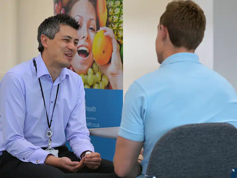 An employee health screening attendee discussing their results and lifestyle